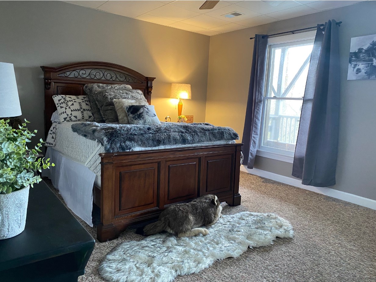 Guest bedroom with a carved wood bed
